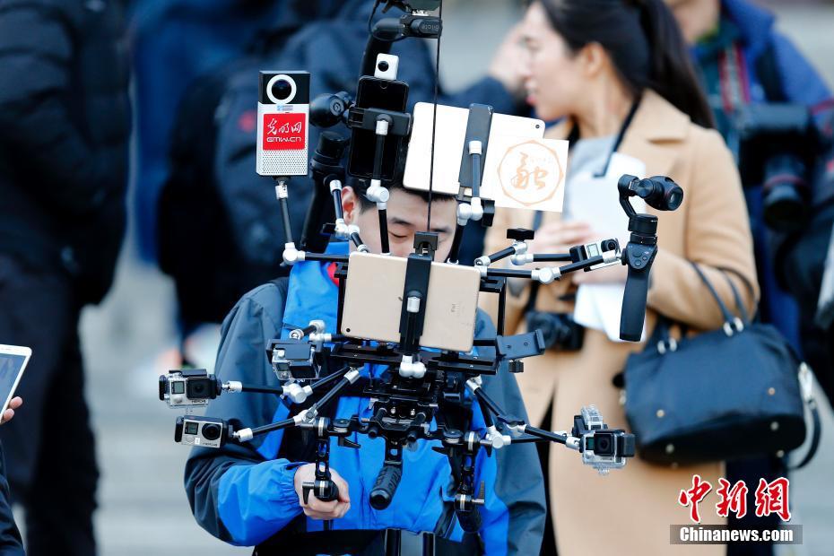 Journalist equipped with 'iron man' broadcast devices during Two Sessions