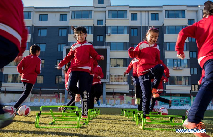 Primary school students participate in soccer training in N China