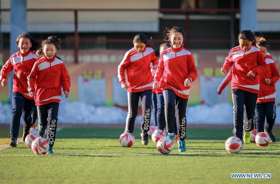 Primary school students participate in soccer training in N China