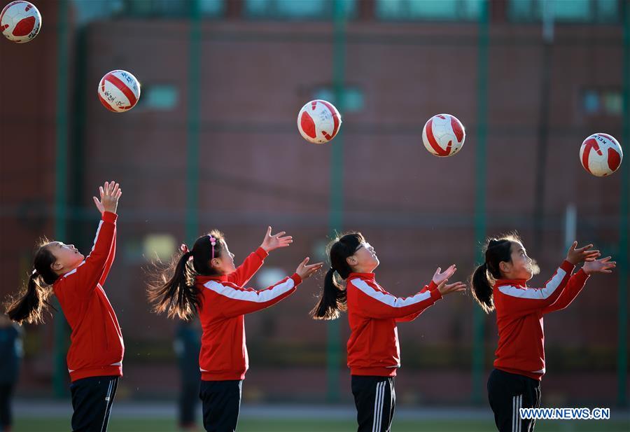 Primary school students participate in soccer training in N China