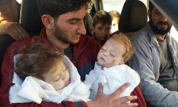 Father shows off twin boy and girl killed in Syria's 'sarin gas massacre', as death toll reaches 72