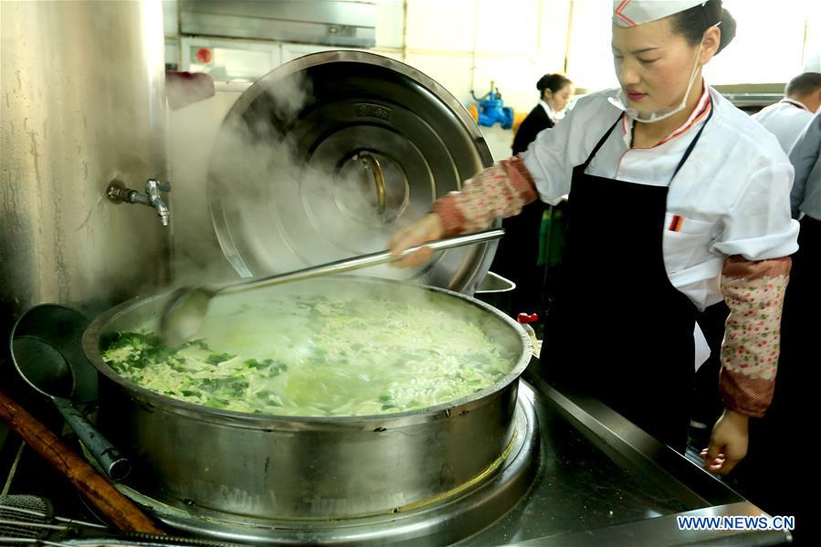 Tourists enjoy firecracker-shaped noodles in Zhangye, NW China's Gansu