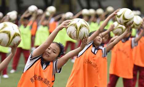 Students do football exercises in Hohhot