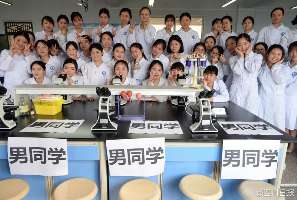 Male nursing school students hold signs to highlight gender in graduation photos 