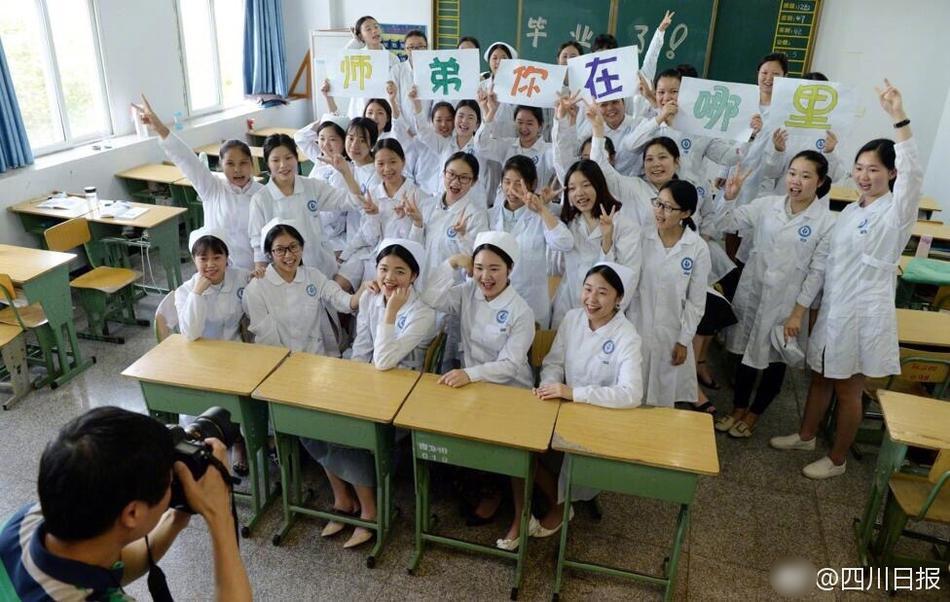 Male nursing school students hold signs to highlight gender in graduation photos 