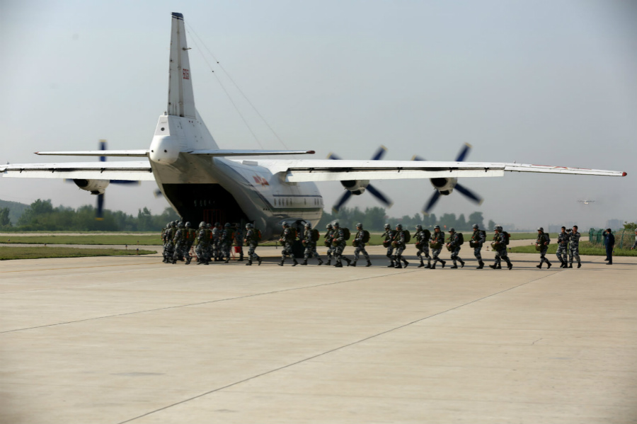 Paratroopers jump out of Y-8 transport aircraft