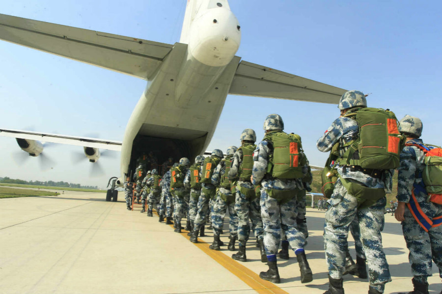 Paratroopers jump out of Y-8 transport aircraft