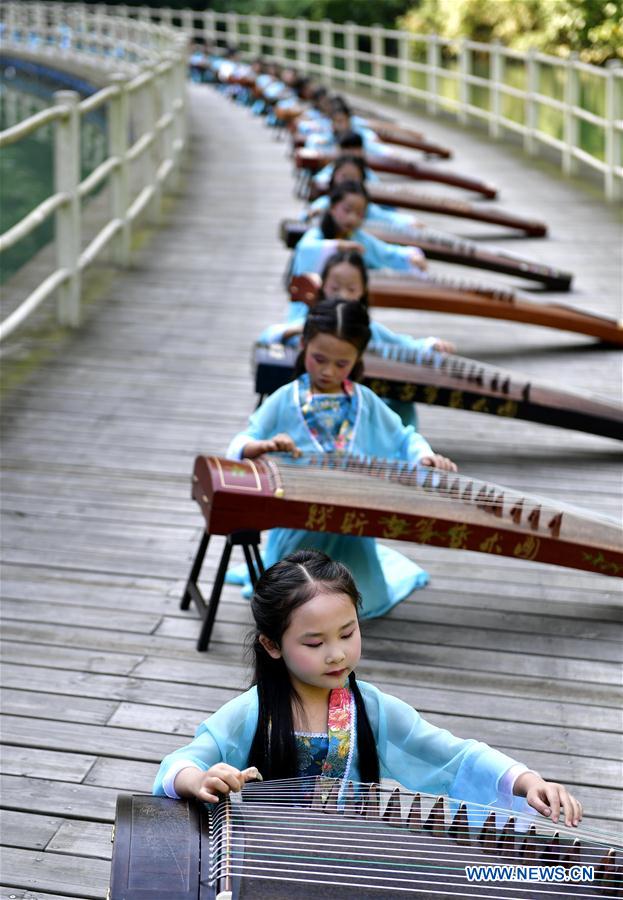 Children play traditional Chinese instrument Guzheng in China's Hubei