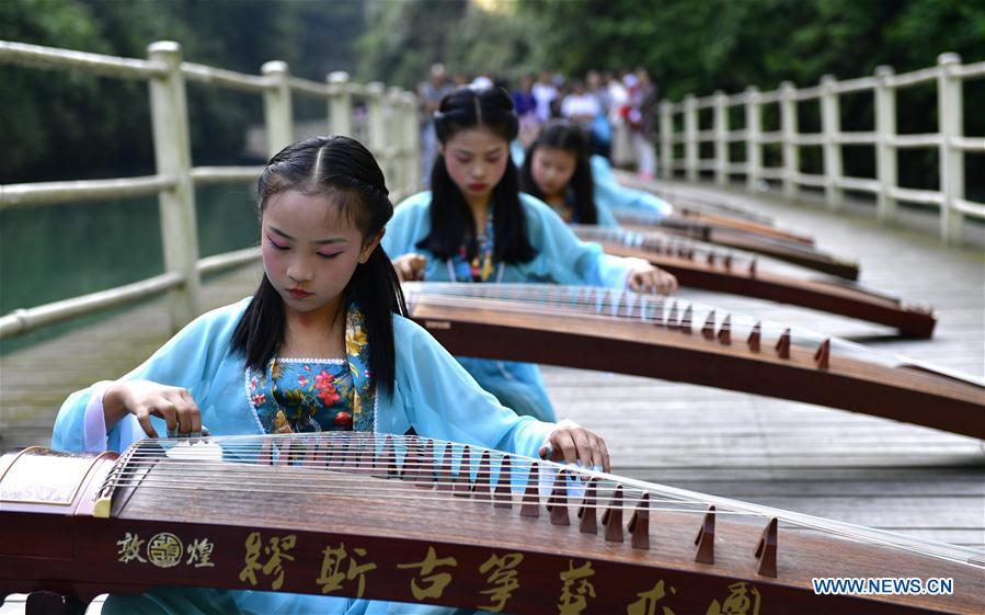 Children play traditional Chinese instrument Guzheng in China's Hubei