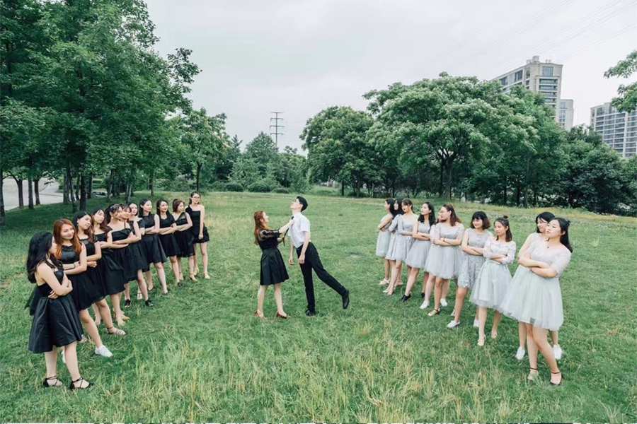Sole male student takes graduation photo with 22 female classmates