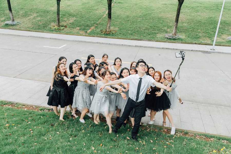 Sole male student takes graduation photo with 22 female classmates