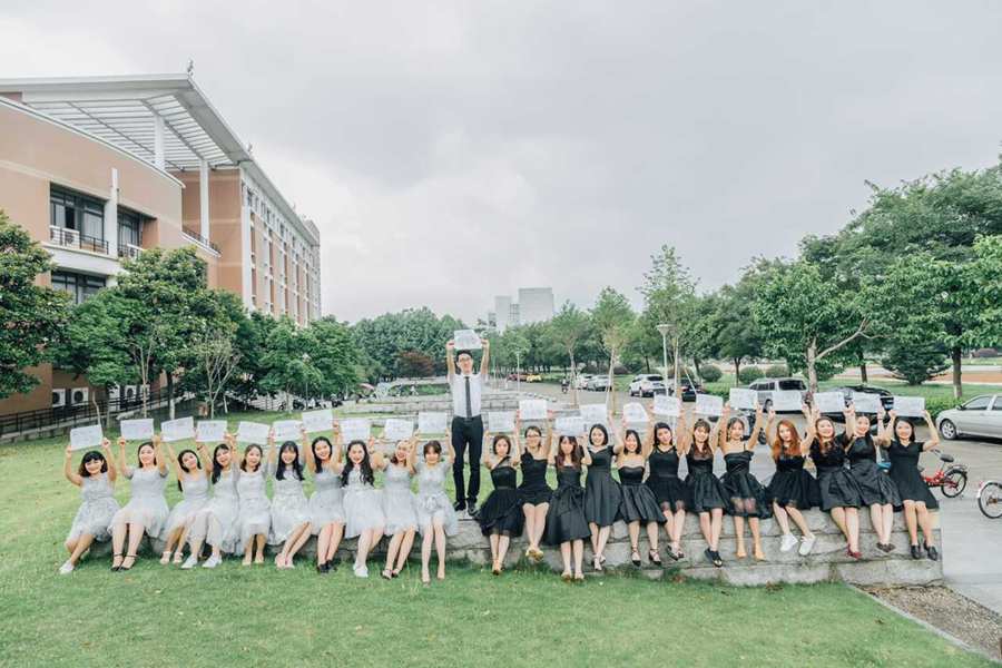 Sole male student takes graduation photo with 22 female classmates