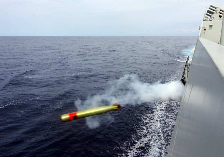 Destroyer fires main gun at night in South China Sea