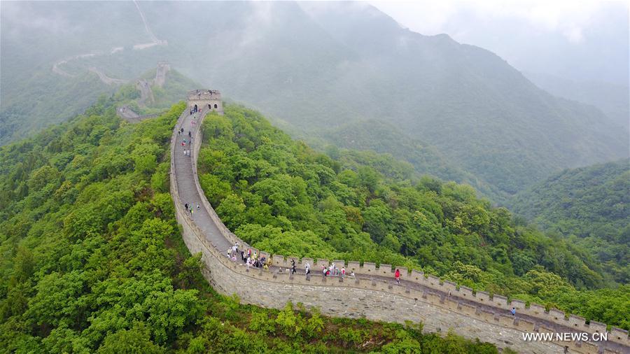 People visit Mutianyu section of Great Wall in mist and rain in Beijing