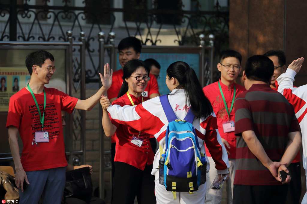 Anxious parents don lucky red clothing outside college entrance exam sites