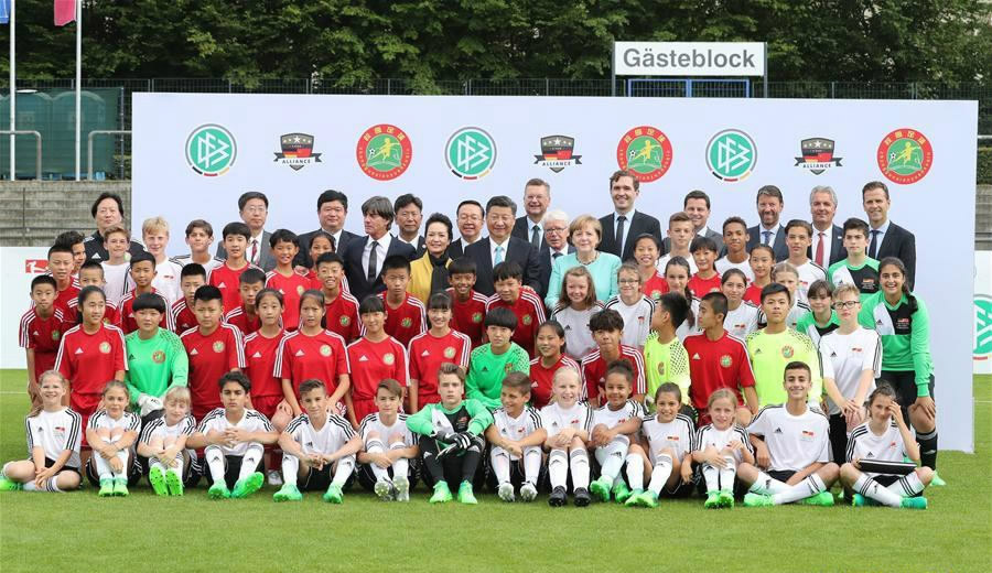 Xi, Merkel watch football match between youths