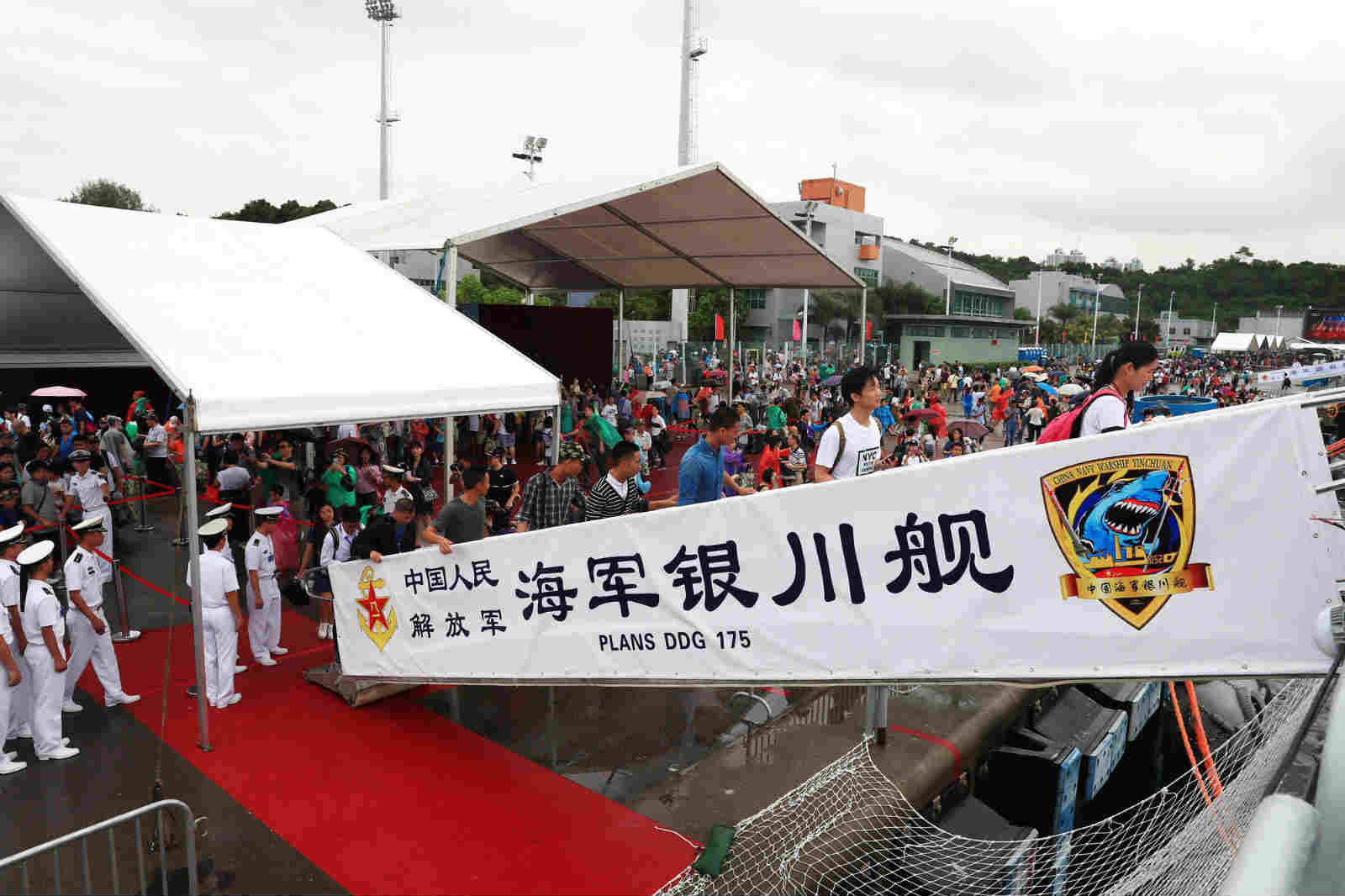 Local residents board the guided-missile destroyer Yinchuan for visits on the camp-open day. In order to celebrate the 20th anniversary of Hong Kong's return to the motherland, the Ngong Shuen Chau Barracks of the PLA Hong Kong Garrison held the camp-open day activities on the morning of July 8, 2017. (eng.chinamil.com.cn/Photo by Zhou Hanqing)