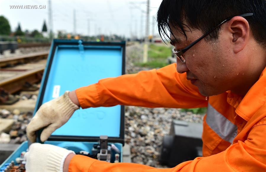 Workers keep working on posts in persistent summer heat