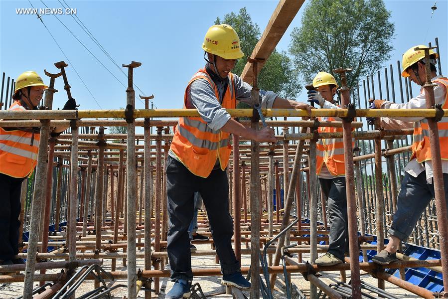 Builders work at construction site in hot summer in N China