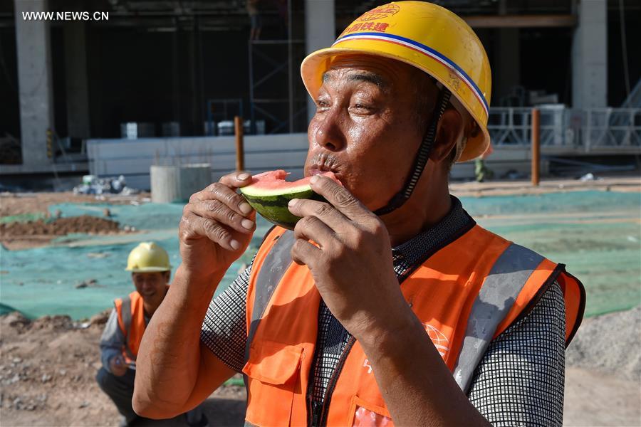 Chinese construction worker with sunhat and hardhat combination