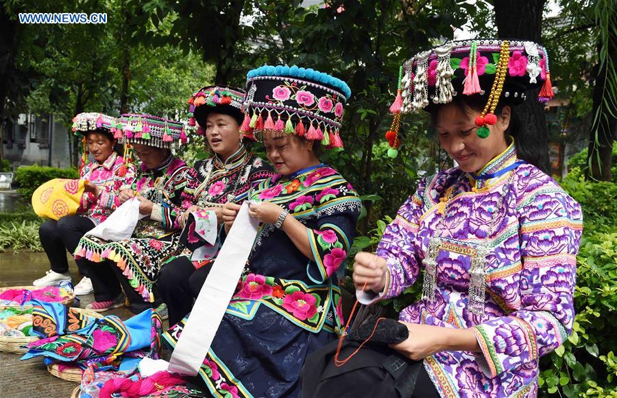 In pics: ethnic embroidery show in SW China's Yunnan