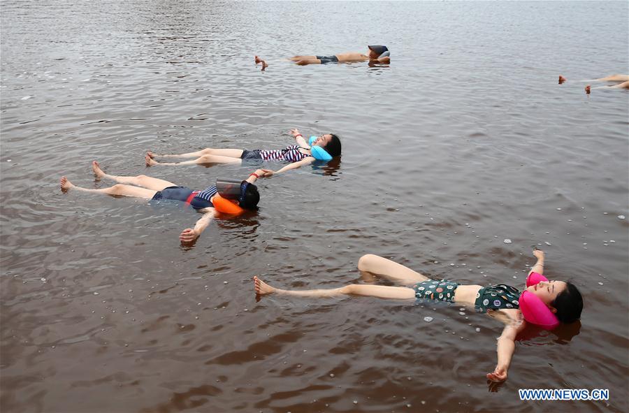 People bath in water with high amount of salt at resort in NE China