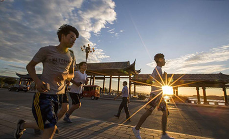 People enjoy outdoor exercises in summer day in China