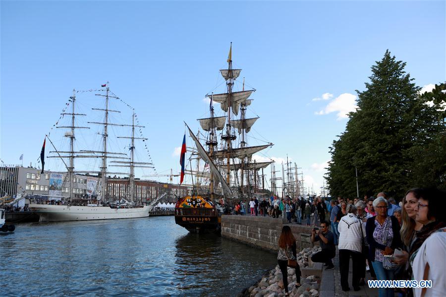 People visit tall ships docked for Tall Ships Races in Turku, Finland