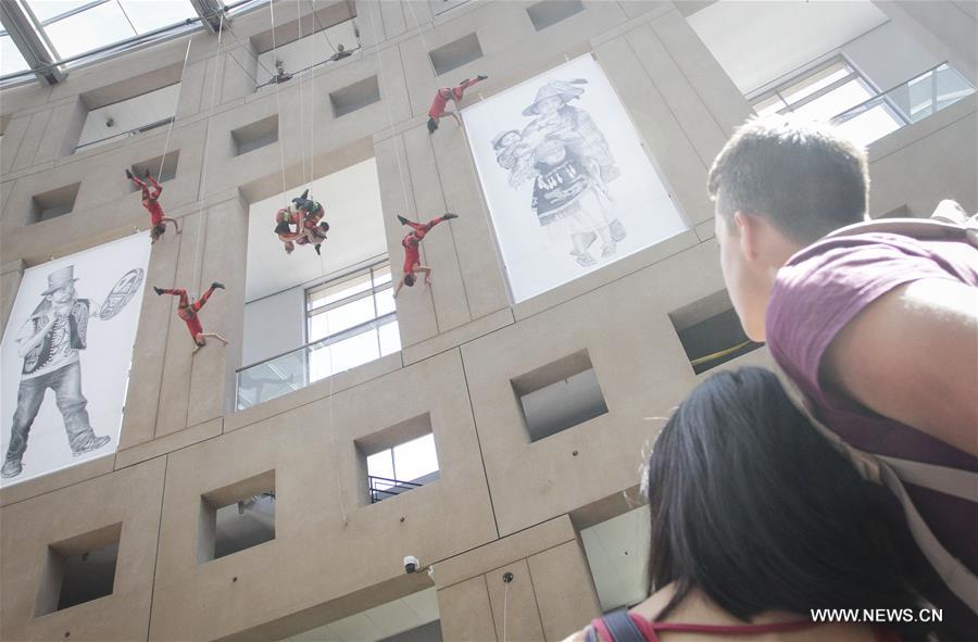 Dancers perform in air on exterior wall of Vancouver Public Library