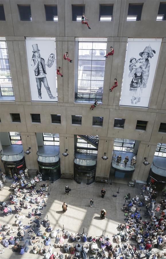Dancers perform in air on exterior wall of Vancouver Public Library