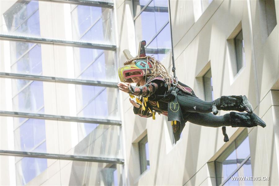 Dancers perform in air on exterior wall of Vancouver Public Library