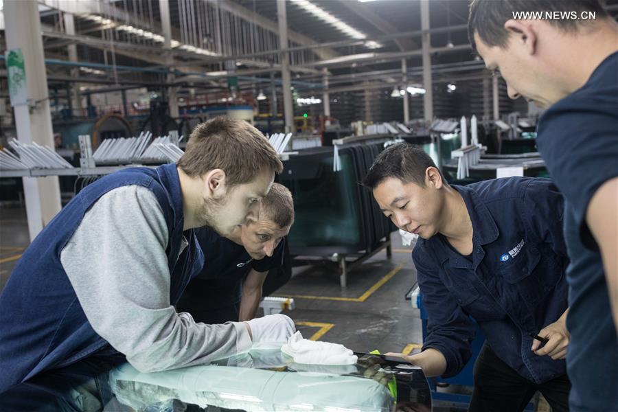 Workers busy at Russian factory of China's Fuyao Glass in Kaluga