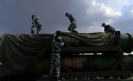 Soldiers load HQ-9 missiles for training