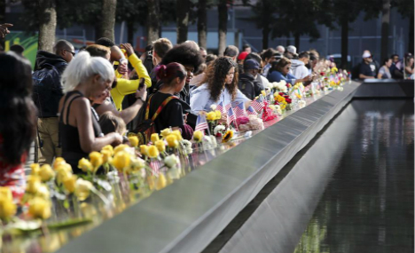 People place flowers to mourn victims of 9/11 terror attacks