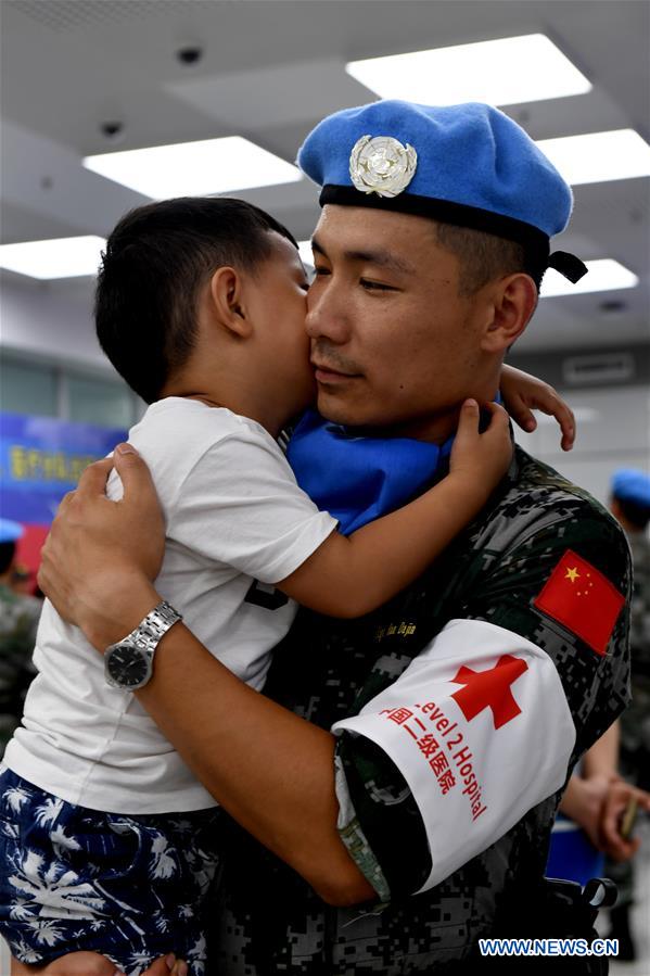 Han Dajin, a Chinese peacekeeper, bids farewell to his three-year-old son before leaving for South Sudan from Zhengzhou, capital of central China's Henan Province, Sept. 21, 2017. The 105-member squad of Chinese peacekeepers left for Wau in South Sudan on a one-year peacekeeping mission. (Xinhua/Zhu Xiang)