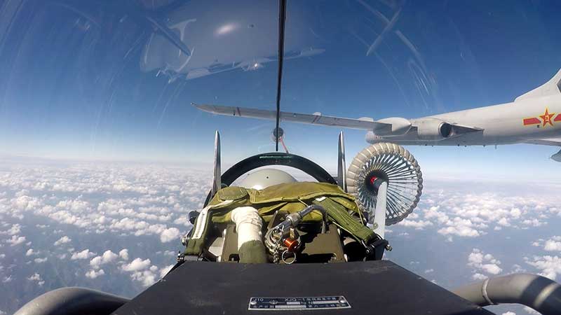 Tanker aircraft pass fuel to fighter jets