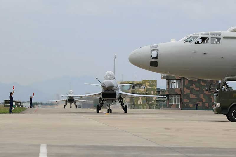 Tanker aircraft pass fuel to fighter jets