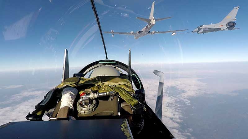 Tanker aircraft pass fuel to fighter jets