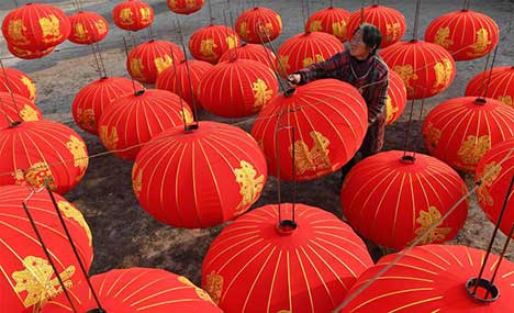 Workers prepare lanterns for upcoming new year