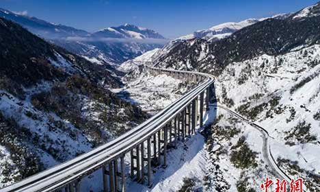 Snow-covered expressway wanders into mountains