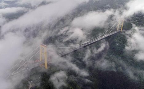 Bridge enveloped by clouds and fog in Enshi