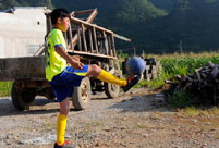Poor mountain children kick out a new life with football
