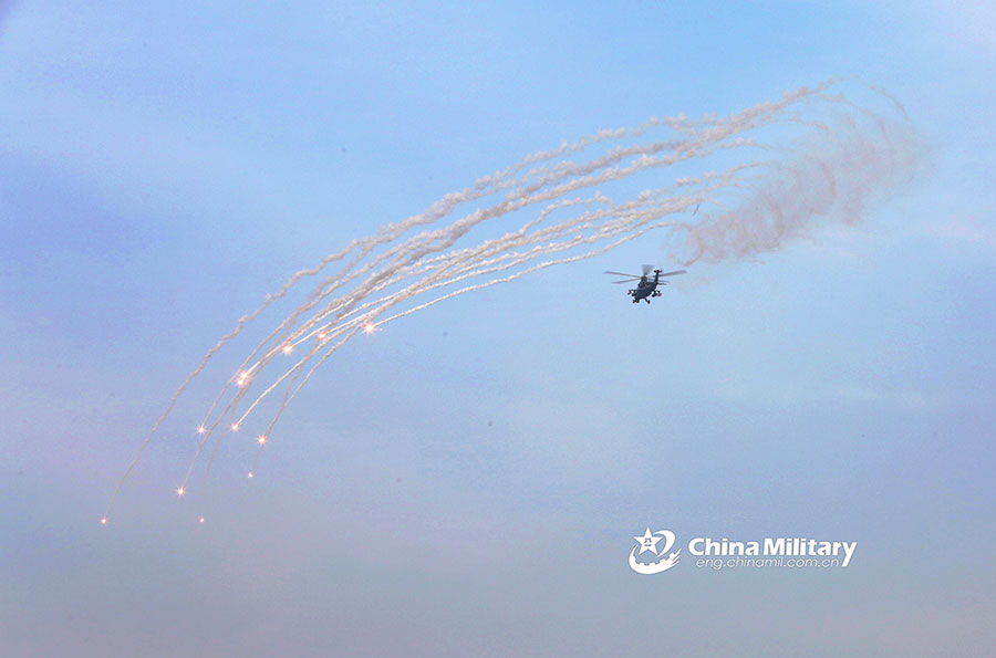 Attack helicopters deploy flares during training