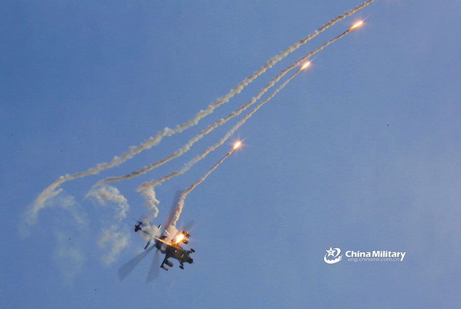 Attack helicopters deploy flares during training