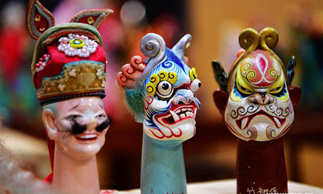 Chinese craftsmen devoted to Zhangzhou wood puppet head carving