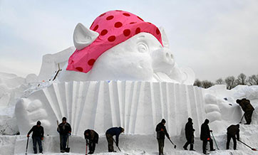 In pics: snow sculpture with "happy pigs" theme in Harbin, NE China