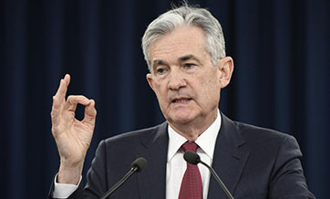 U.S. Fed raises rates, but signals slower pace of hikes next year