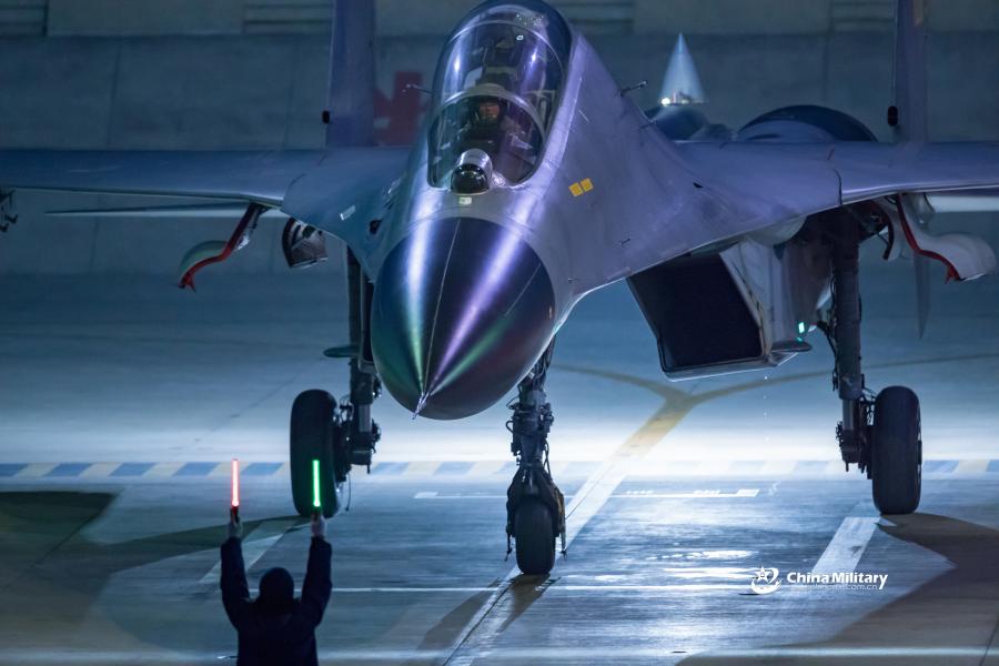 J-11B fighter jet flies past the sun