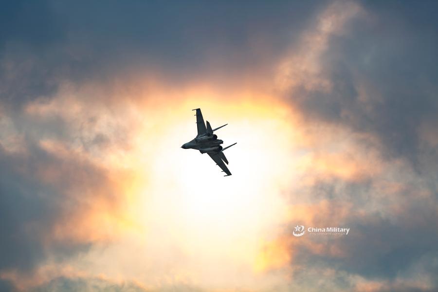 J-11B fighter jet flies past the sun