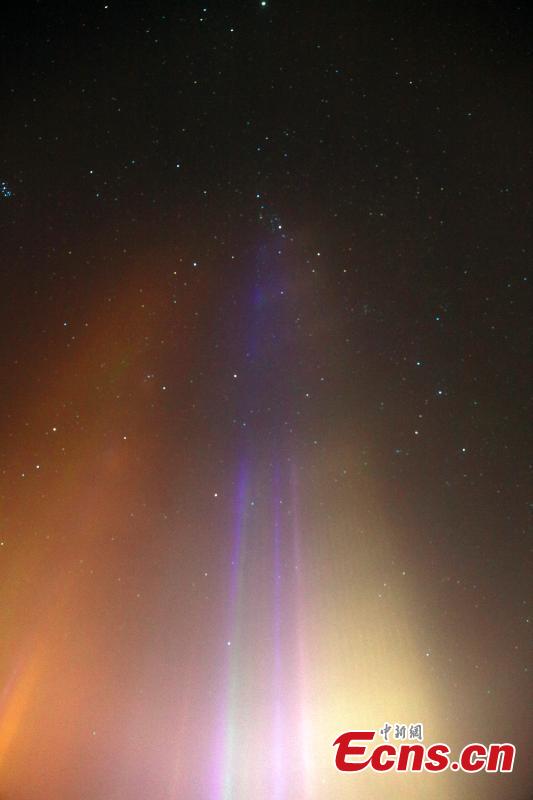 Light beam-sword cuts through night in cold northwestern village